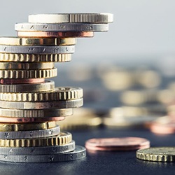 Close up of a stack of coins next to scattered coins