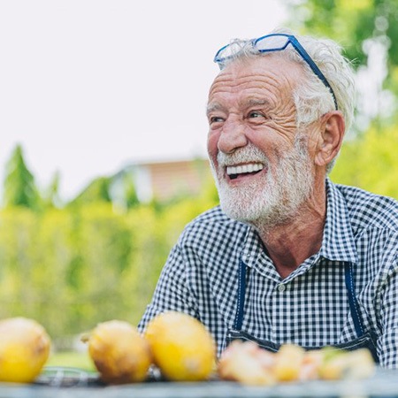 Man smiles outdoors