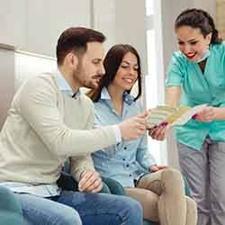 Patient in Savannah talking with dentist about dentures financing